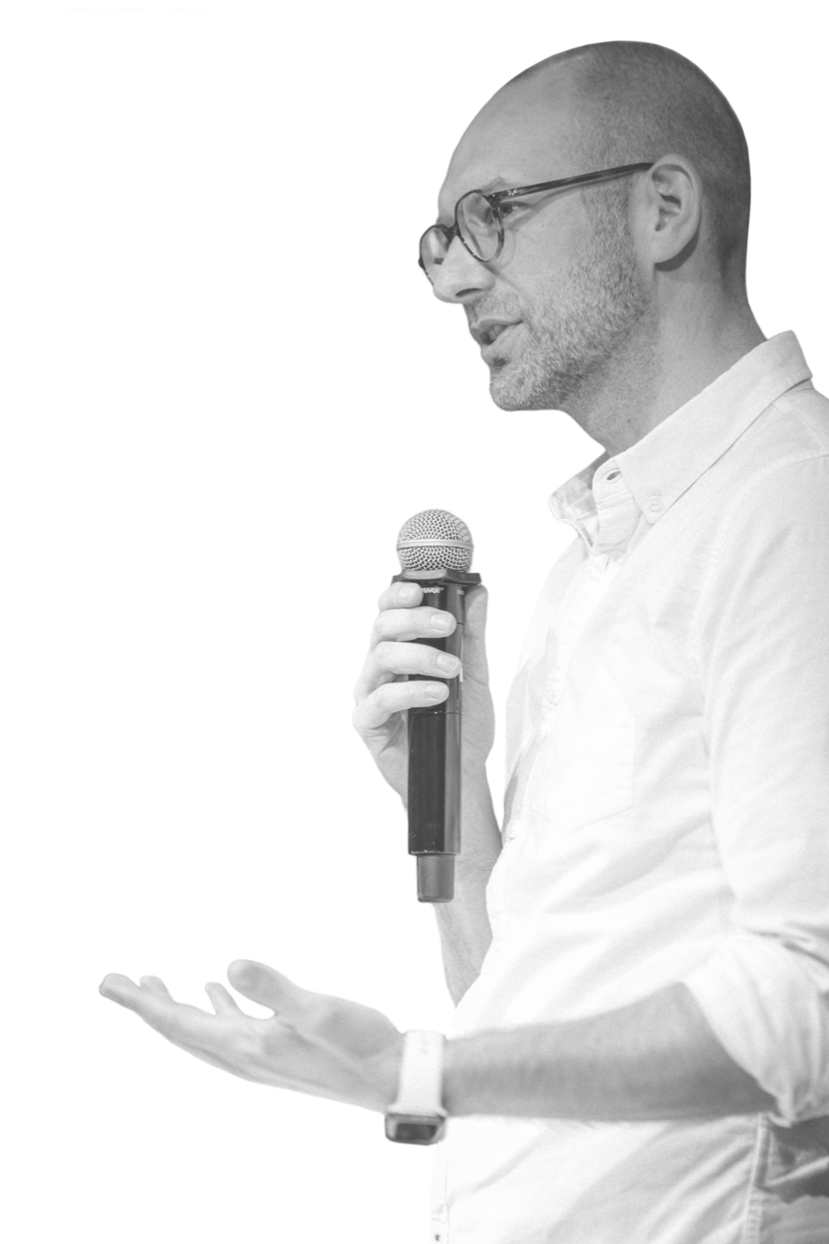 Marcin Ukleja speaking into a microphone